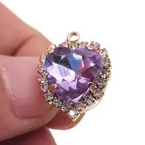 Sparkling heart-shaped purple crystal pendant with rose gold border and white rhinestones