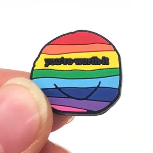Dettaglio del ciondolo per scarpe in PVC arcobaleno con la frase ispiratrice You are worth it