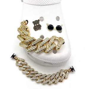 Golden rhinestone cuban chain and bear shoe charms set on white clog shoes