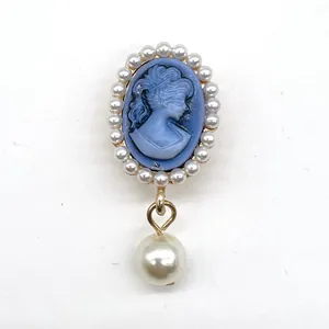 Detail of vintage cameo shoe charm with blue base, pearl border, and teardrop pearl