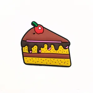 Detail of PVC chocolate cake charm with red cherry for garden shoes decoration