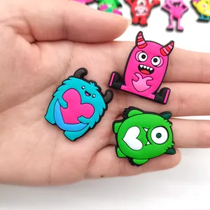 Close-up of cute cartoon monster PVC charms with heart motifs for garden shoes DIY decor