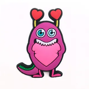 Detail of purple cartoon monster PVC shoe charm with heart antennas and pink heart belly