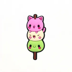 Close-up of cute 3-color PVC cat dango food charms for clogs and garden shoe accessories