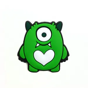 Green one-eyed monster shoe charm with heart pattern for DIY garden clogs decoration