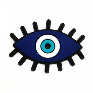 Blue evil eye PVC shoe charm accessory for clogs with eyelash detail on white back