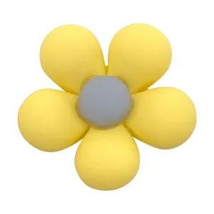 Close-up of a yellow resin flower charm shoe decoration with a matte finish