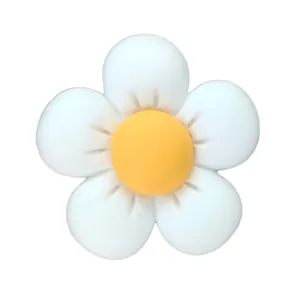 Detailed view of white and yellow resin flower charm for DIY garden shoe decoration
