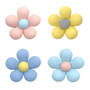 Set of four colorful matte resin flower charms for clogs in pink, yellow and blue shades
