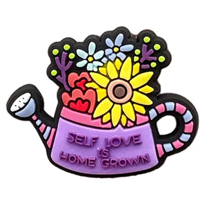 Macro detail of PVC floral watering can shoe charm with Self Love Is Home Grown text