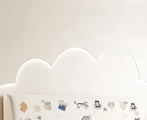 Detail view of cream white cloud-shaped headboard cover with cute cat cartoon patterns