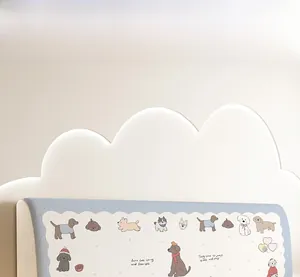 Detail of light blue universal headboard cover featuring cartoon dogs and wavy lace edges