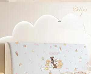 Detail of light blue velvet headboard cover with cute cartoon dogs and dessert patterns