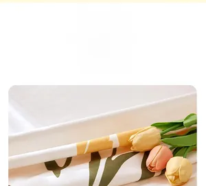Close-up of soft white fabric headboard cover with yellow tulip floral pattern and texture