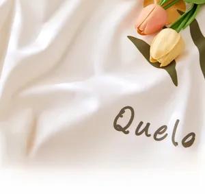 Close-up of white bedside cover fabric with tulip print and soft texture details