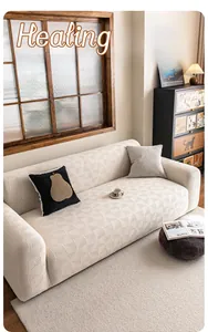 Detail of cream elastic sofa cover with textured wave pattern and matching pillow
