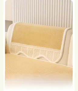 Detail of cream waffle corduroy sofa cushion with elegant ruffled lace and plush edging