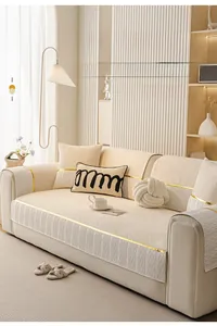 Close-up of cream chenille sofa cushion with gold trim and skin-friendly fabric texture