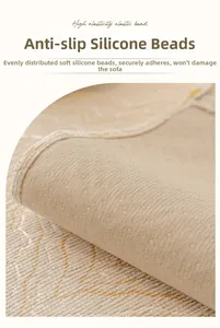 Close-up of non-slip silicone particles and elastic strap on beige chenille sofa cover