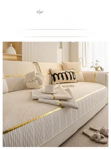 Detail of beige chenille sofa cover featuring wave texture and elegant gold metallic trim