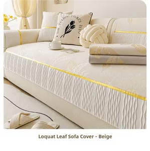 Detail of beige chenille sofa cushion featuring embossed loquat leaf pattern and silk edging