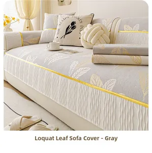 Close-up of gray chenille sofa cover with yellow loquat leaf patterns and ruffled lace