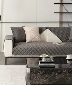 Detail of grey honeycomb quilted flannel sofa cover with non-slip texture and modern design
