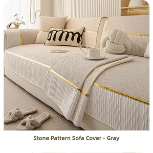 Detail of grey marble chenille sofa cover with gold piping and pleated hem design