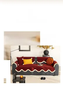 Detailed close-up of velvet sofa cushion featuring white scalloped edges and plush balls
