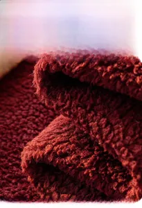 Detail of red Angora cloud velvet fabric showing thick plush texture and soft fiber