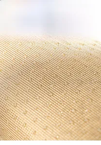 Macro view of anti-slip silicone granule bottom on plush sofa cushion fabric
