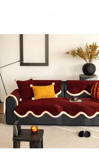Detailed texture of dark red plush sofa cushion with white wavy fleece edge decoration