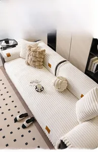 Detail of off-white corduroy texture cushion with soft plush ball fringe edges