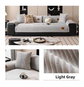 Detail of light gray thickened rabbit plush sofa cushion with soft striped texture and pom-poms