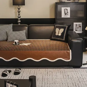 Houndstooth non-slip sofa cushion with brown leather trim and white plush wavy edges