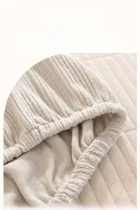 Macro detail showing high elasticity elastic band on a beige knitted headboard cover