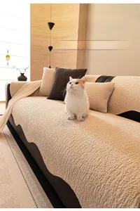 Detail of beige chenille sofa cover with waffle texture and matching cushion in living room
