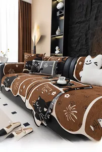 Close-up of chenille sofa mat with cute black cat pattern and soft fabric texture