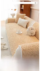 Detail of cream-colored plush sofa cover with 3D geometric texture and floral pattern
