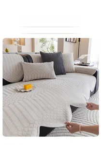 Detail showing beige chenille sofa cover with patchwork textures and pleated wavy edges