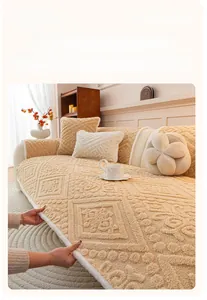 Close-up of beige plush sofa cover featuring vintage geometric embossed patterns and texture