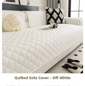 Detail of off-white quilted sofa cover with diamond patterns in a modern living room