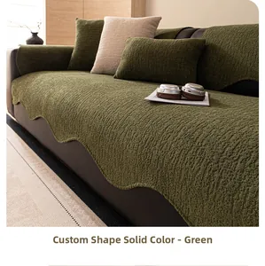 Detail of green chenille sofa cover featuring irregular wavy edges and textured fabric
