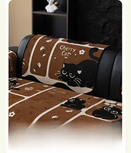 Detail of chenille sofa cushion featuring vintage cartoon black cat and fish bone patterns
