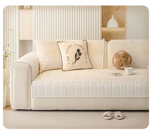 Detail of chenille sofa cushion with textured jacquard fabric and white lace fringe