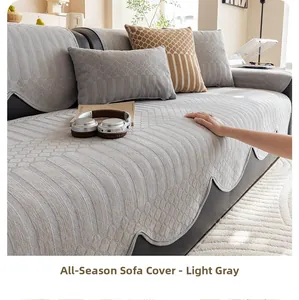 Detail of light grey chenille sofa cushion with quilted texture and wavy edges