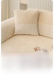 Detail of cream chenille sofa cushion showing 3D striped texture and white lace edges