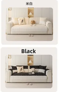 Close-up of off-white and black chenille sofa cushions with textured fringe and tassels