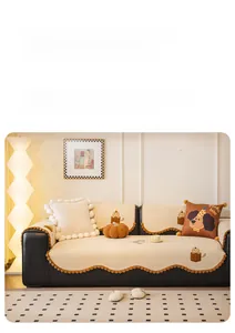 Close-up of thick Teddy velvet sofa cover with brown wavy lace and soft pumpkin cushion