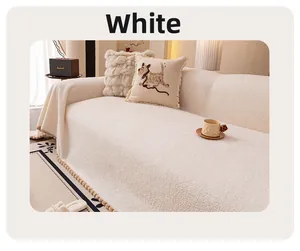 Gros plan sur la housse de canapé en laine d'agneau blanche avec pompons décoratifs